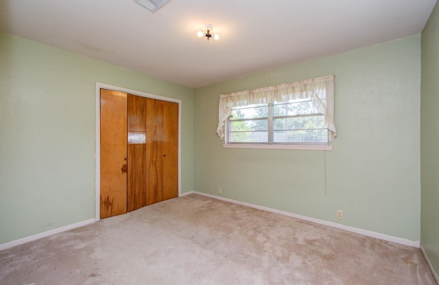 unfurnished bedroom featuring carpet floors and a closet