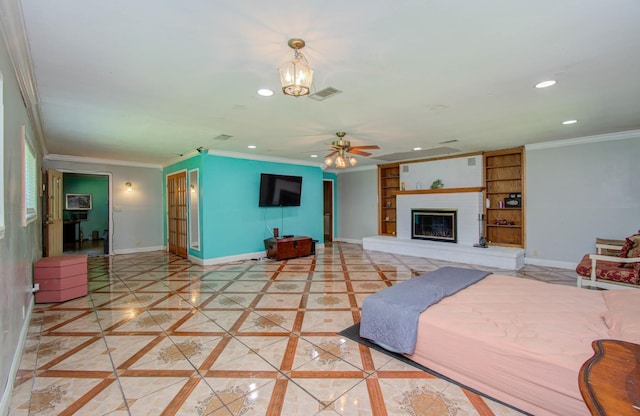 living room featuring built in shelves, crown molding, a fireplace, and ceiling fan with notable chandelier