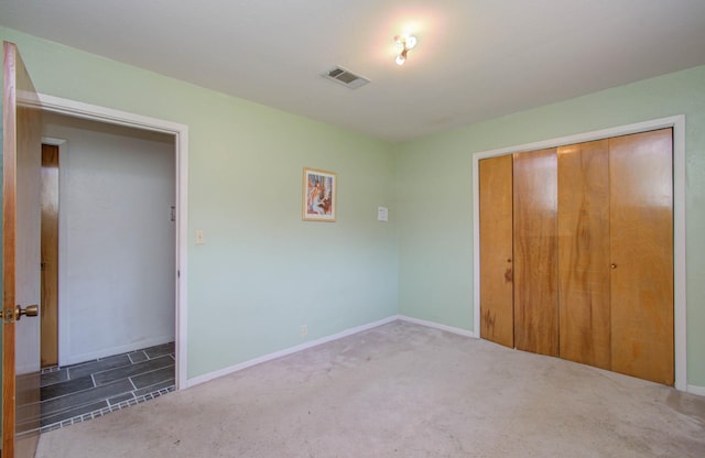 unfurnished bedroom featuring carpet floors and a closet