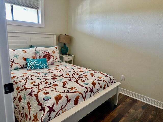 560 Pleasure Island Blvd, Port Arthur, TX 77640 - bedroom with dark wood finished floors and baseboards