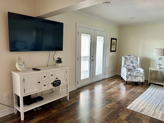560 Pleasure Island Blvd, Port Arthur, TX 77640 - sitting room with french doors, ornamental molding, dark wood-type flooring, baseboards, and a textured ceiling
