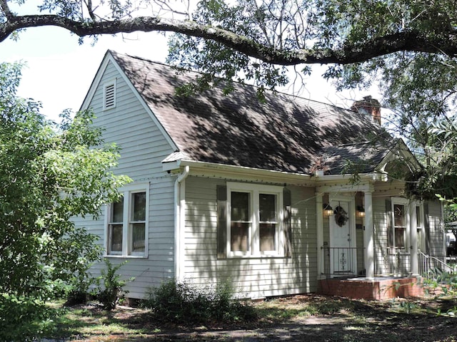 4545 Hollywood Dr, Port Arthur, TX 77642 - view of front facade featuring a chimney and roof with shingles