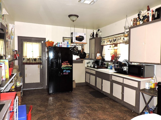 4545 Hollywood Dr, Port Arthur, TX 77642 - kitchen featuring black refrigerator with ice dispenser and white cabinets