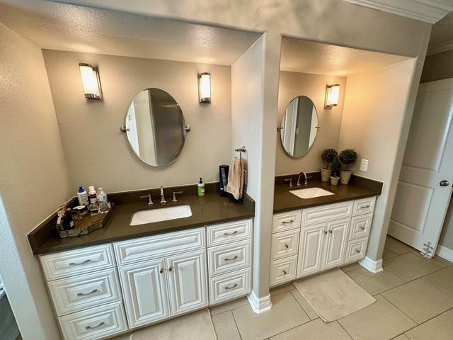 bathroom featuring tile patterned flooring, vanity, and ornamental molding