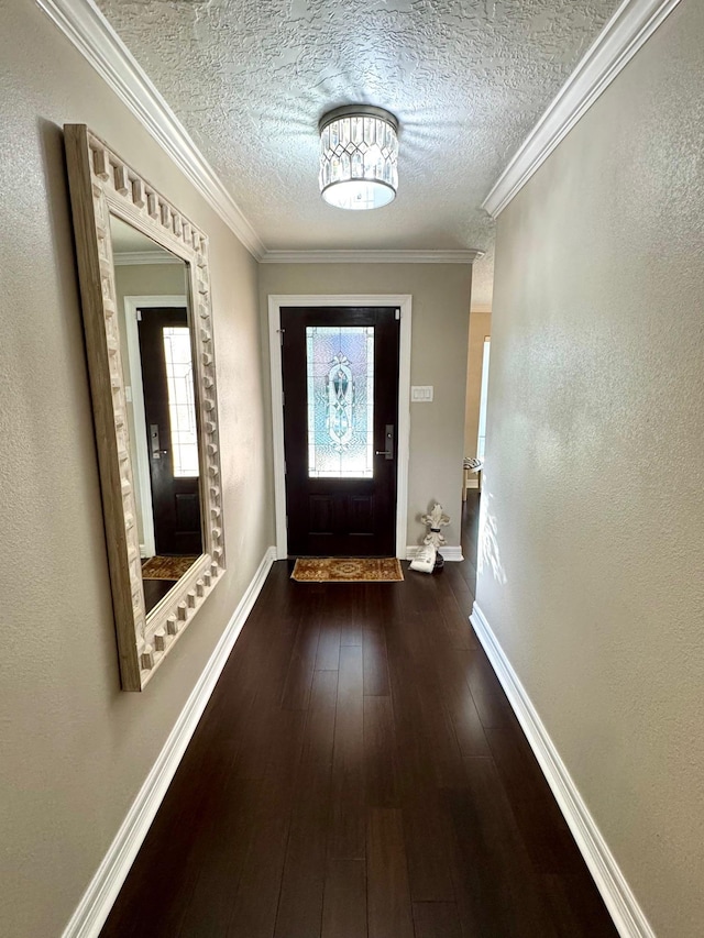 doorway to outside featuring a textured ceiling, dark hardwood / wood-style floors, and crown molding