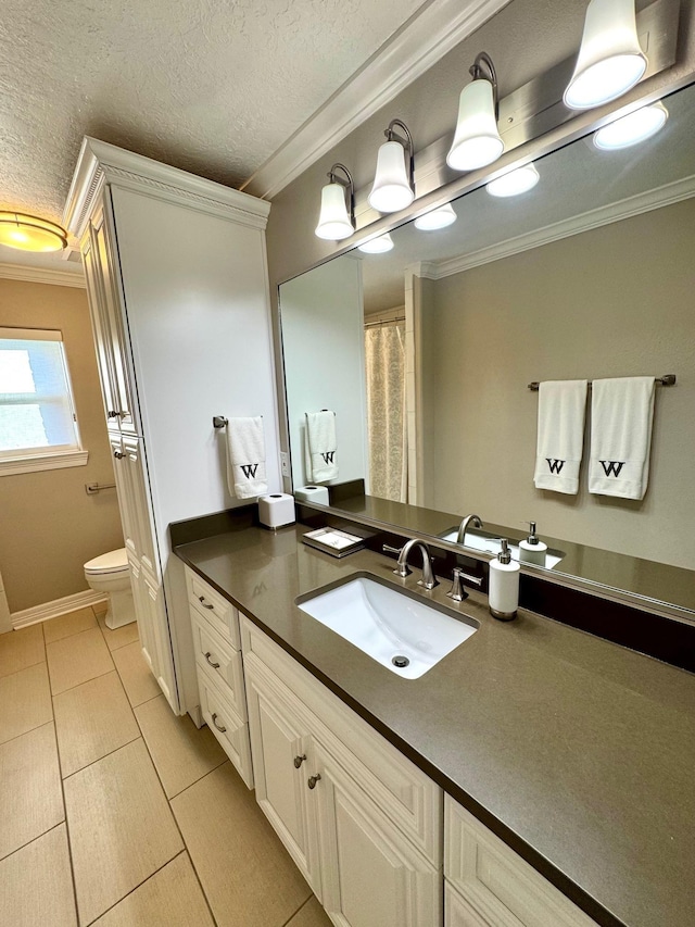 bathroom with a textured ceiling, vanity, toilet, and ornamental molding