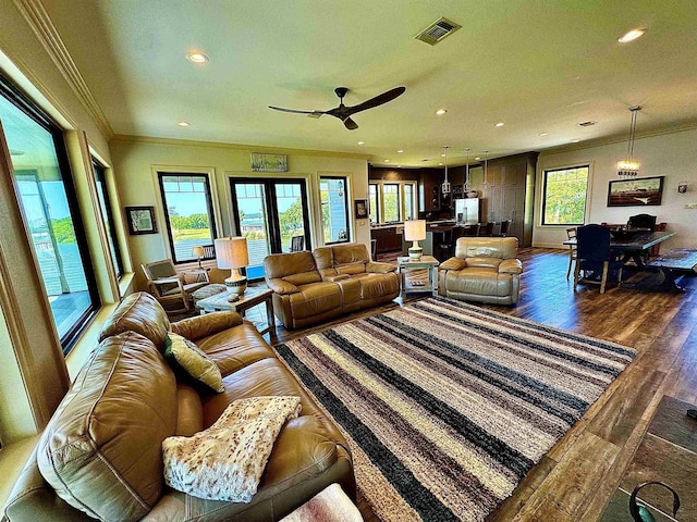 living room featuring recessed lighting, visible vents, ornamental molding, and dark wood finished floors
