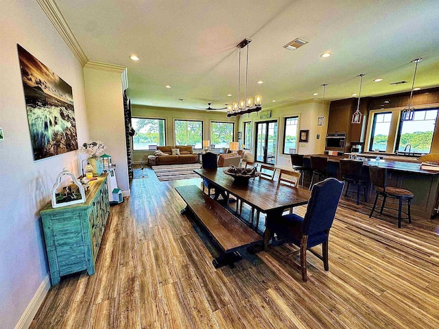 dining area featuring visible vents, recessed lighting, plenty of natural light, and wood finished floors