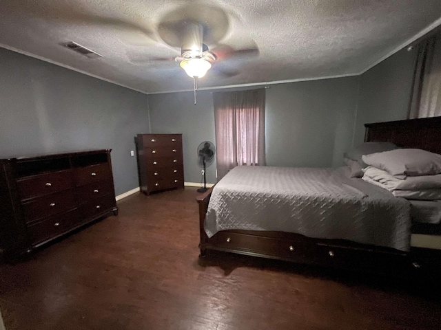 bedroom with ceiling fan and a textured ceiling