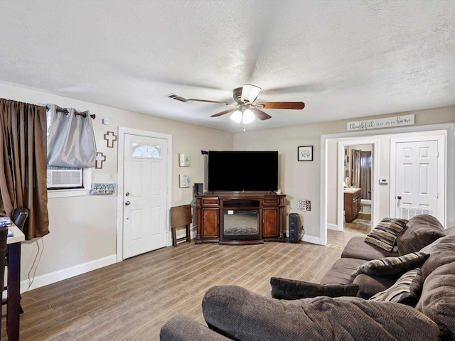 4015 42nd St, Port Arthur, TX 77642 - living room with cooling unit, ceiling fan, light wood-style floors, and a textured ceiling