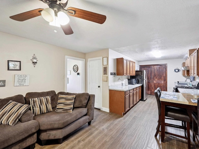4015 42nd St, Port Arthur, TX 77642 - living room with light wood-style floors and ceiling fan