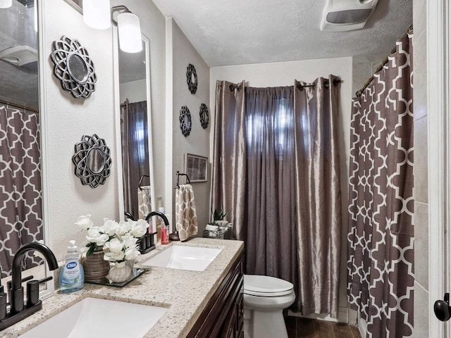4015 42nd St, Port Arthur, TX 77642 - bathroom featuring double vanity and a textured ceiling