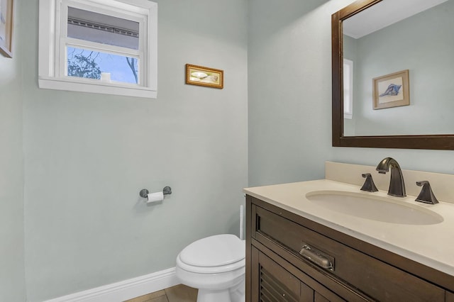 5855 Gladys Ave, Beaumont, TX 77706 - half bathroom featuring toilet, vanity, tile patterned floors, and baseboards