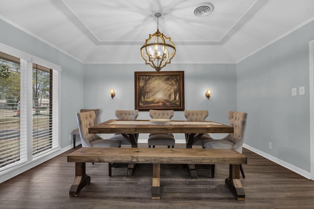 5855 Gladys Ave, Beaumont, TX 77706 - dining room featuring a tray ceiling, a chandelier, wood finished floors, baseboards, and crown molding