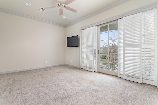 spare room with crown molding, light carpet, and ceiling fan