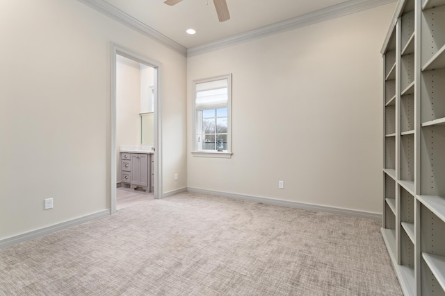 unfurnished bedroom featuring crown molding, light colored carpet, ceiling fan, and ensuite bathroom