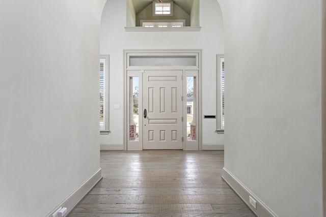 entryway with light hardwood / wood-style flooring, plenty of natural light, and high vaulted ceiling