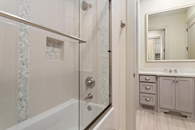 bathroom with vanity and shower / bath combination with glass door