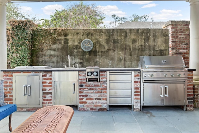 view of patio / terrace featuring area for grilling, sink, and grilling area