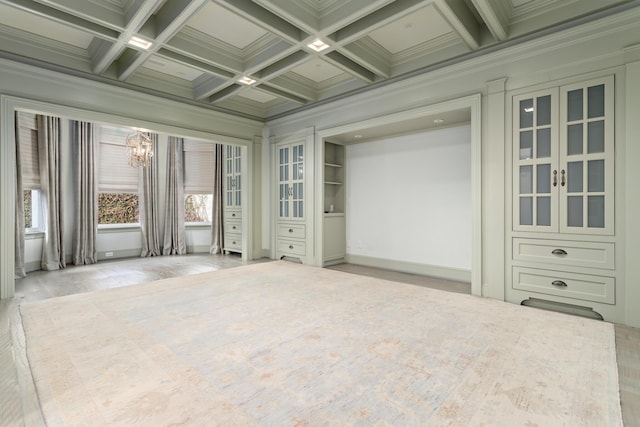 unfurnished sunroom featuring beamed ceiling, coffered ceiling, french doors, and a notable chandelier