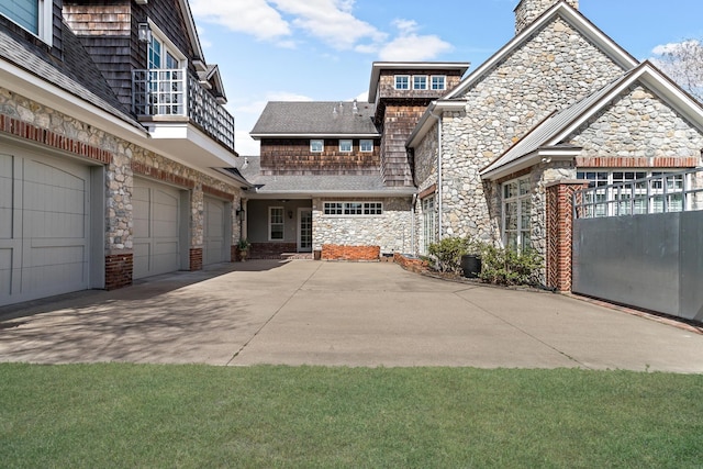 view of side of home with a garage and a balcony