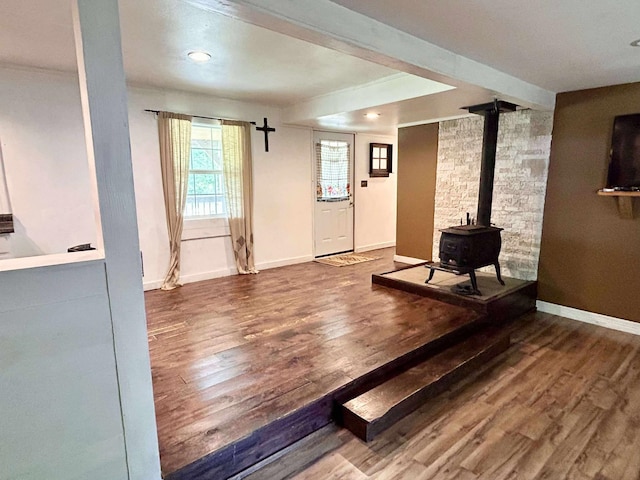 2522 Tucker Rd, Silsbee, TX 77656 - unfurnished living room featuring a wood stove, wood finished floors, baseboards, and recessed lighting