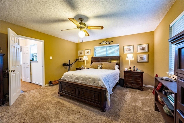 carpeted bedroom with ceiling fan and a textured ceiling