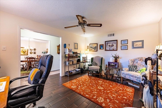 office area with ceiling fan with notable chandelier and a textured ceiling