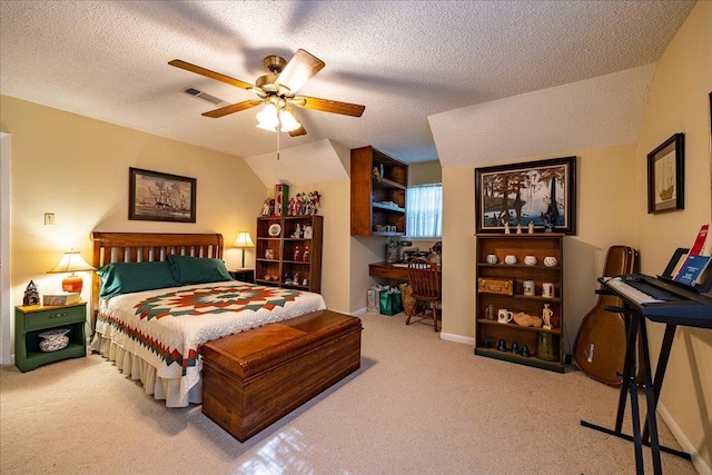 carpeted bedroom with a textured ceiling, ceiling fan, and vaulted ceiling