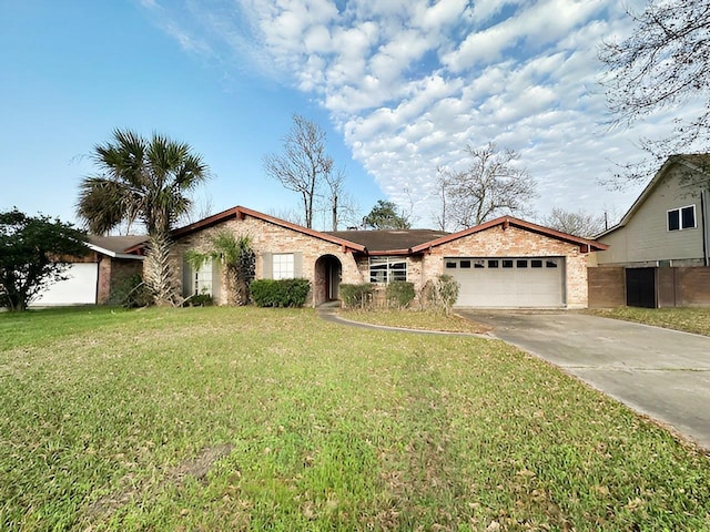 single story home featuring a garage, concrete driveway, brick siding, and a front yard