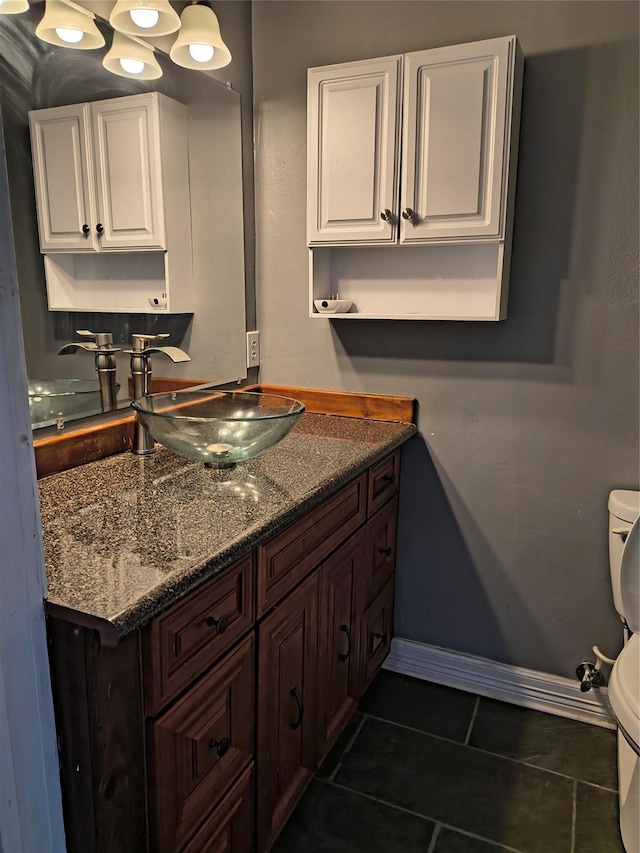 bathroom with tile patterned floors, vanity, and toilet