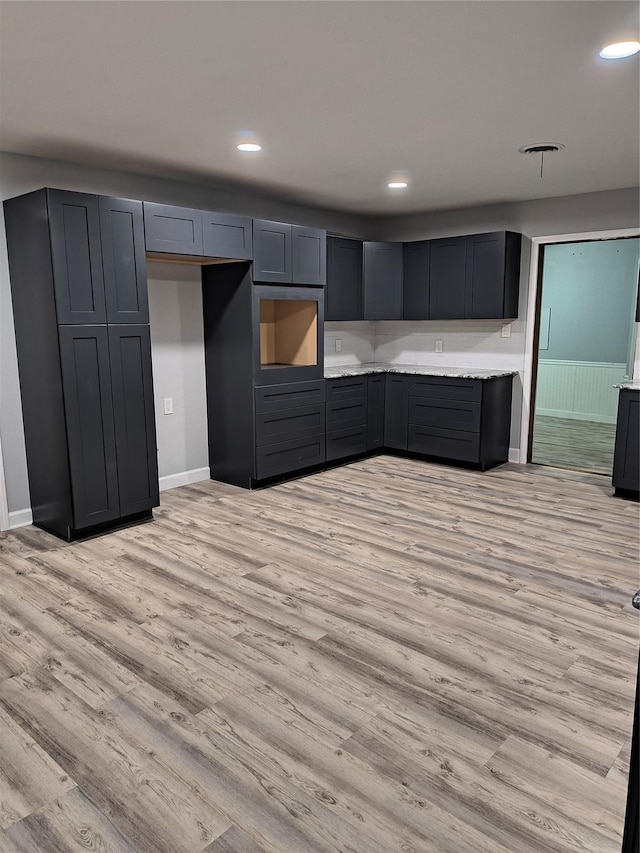 kitchen featuring light wood-type flooring and gray cabinets