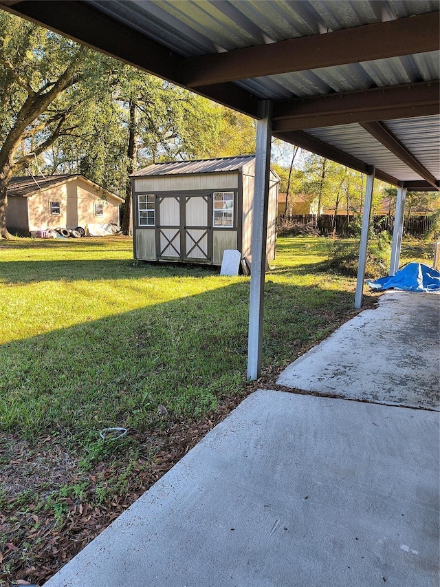 view of yard with a storage shed and a patio