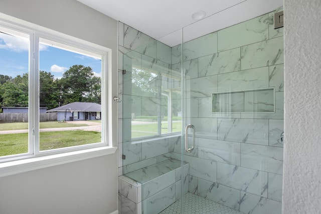 bathroom featuring a shower with shower door