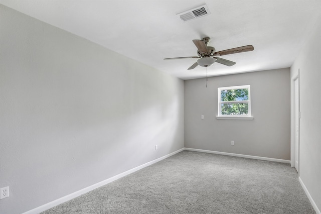 spare room featuring carpet flooring and ceiling fan