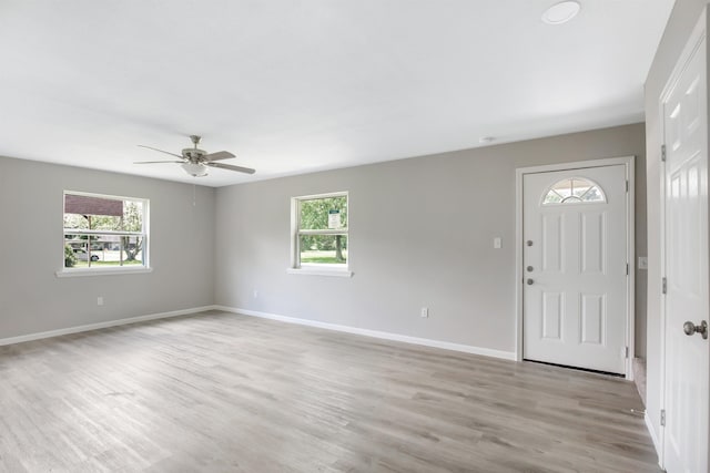 foyer entrance with light hardwood / wood-style floors and ceiling fan