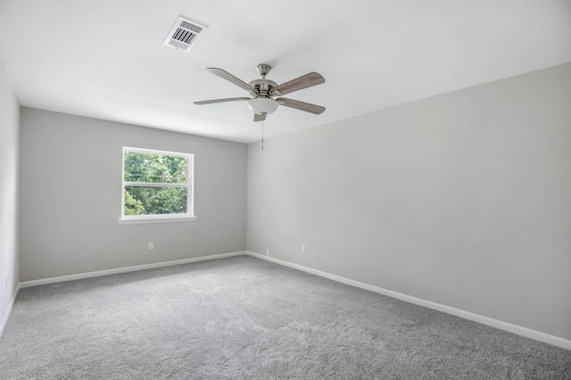 carpeted spare room featuring ceiling fan