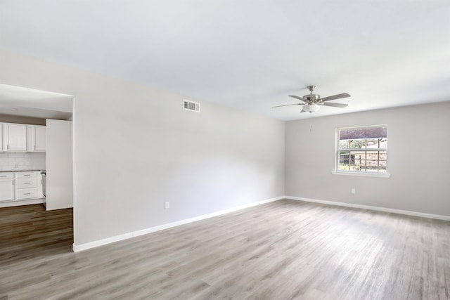 empty room featuring ceiling fan and light hardwood / wood-style floors