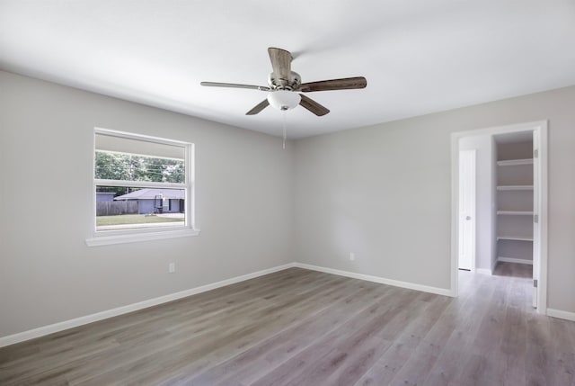 spare room featuring light hardwood / wood-style flooring and ceiling fan