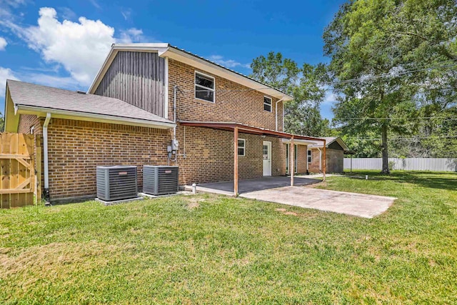 rear view of property featuring a patio area, a yard, and central AC