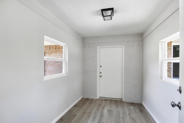 doorway with light wood-type flooring