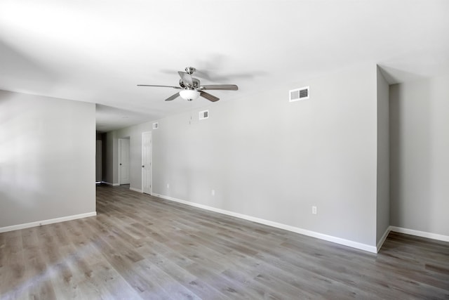 spare room with light wood-type flooring and ceiling fan