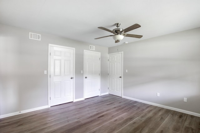 unfurnished bedroom with ceiling fan and dark hardwood / wood-style floors