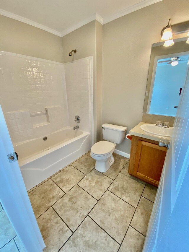 full bath with shower / bathtub combination, toilet, ornamental molding, vanity, and tile patterned floors