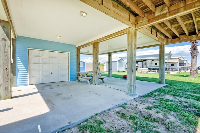 view of patio / terrace with a carport and concrete driveway