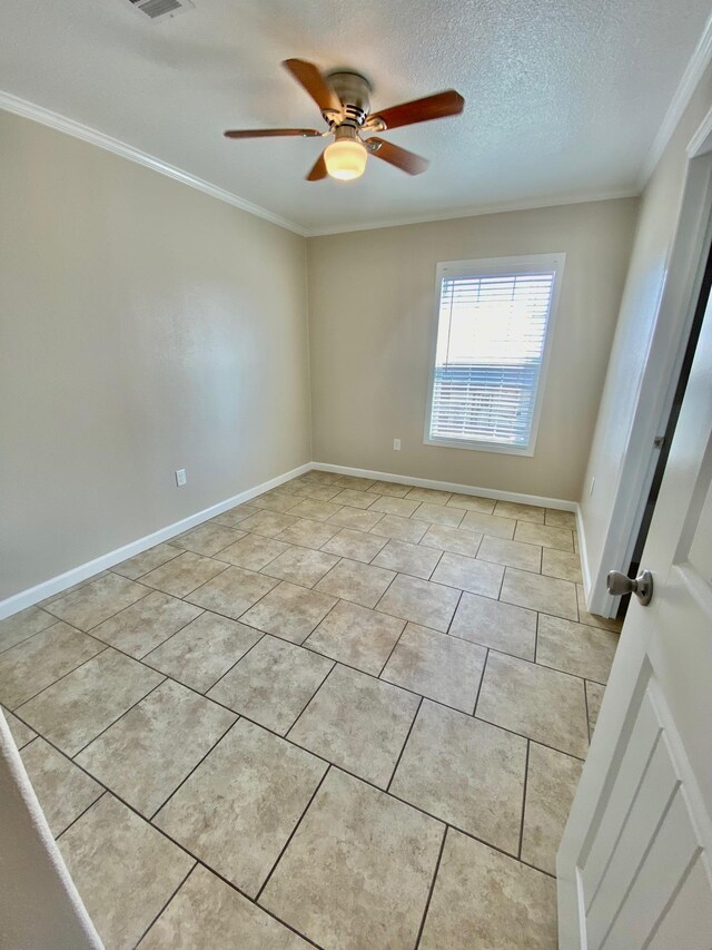 unfurnished room featuring visible vents, ornamental molding, a ceiling fan, a textured ceiling, and baseboards