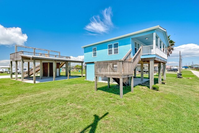 back of property with stairs, a patio, a deck, and a lawn