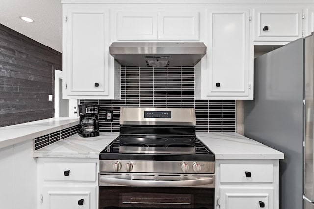 kitchen featuring white cabinetry, stainless steel appliances, light stone counters, ventilation hood, and decorative backsplash