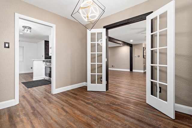 unfurnished dining area featuring french doors and dark wood-type flooring