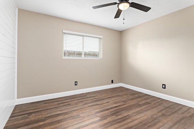 spare room featuring dark hardwood / wood-style floors and ceiling fan